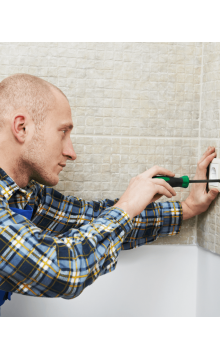 Electrician installing wall outlets 
